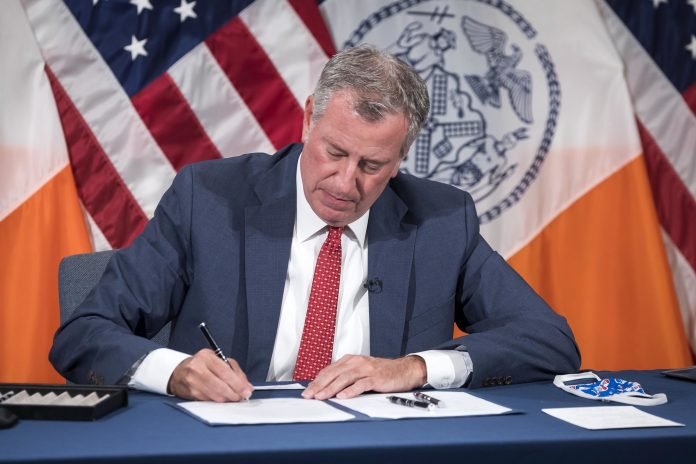 NYC Mayor Signing a Bill into Law